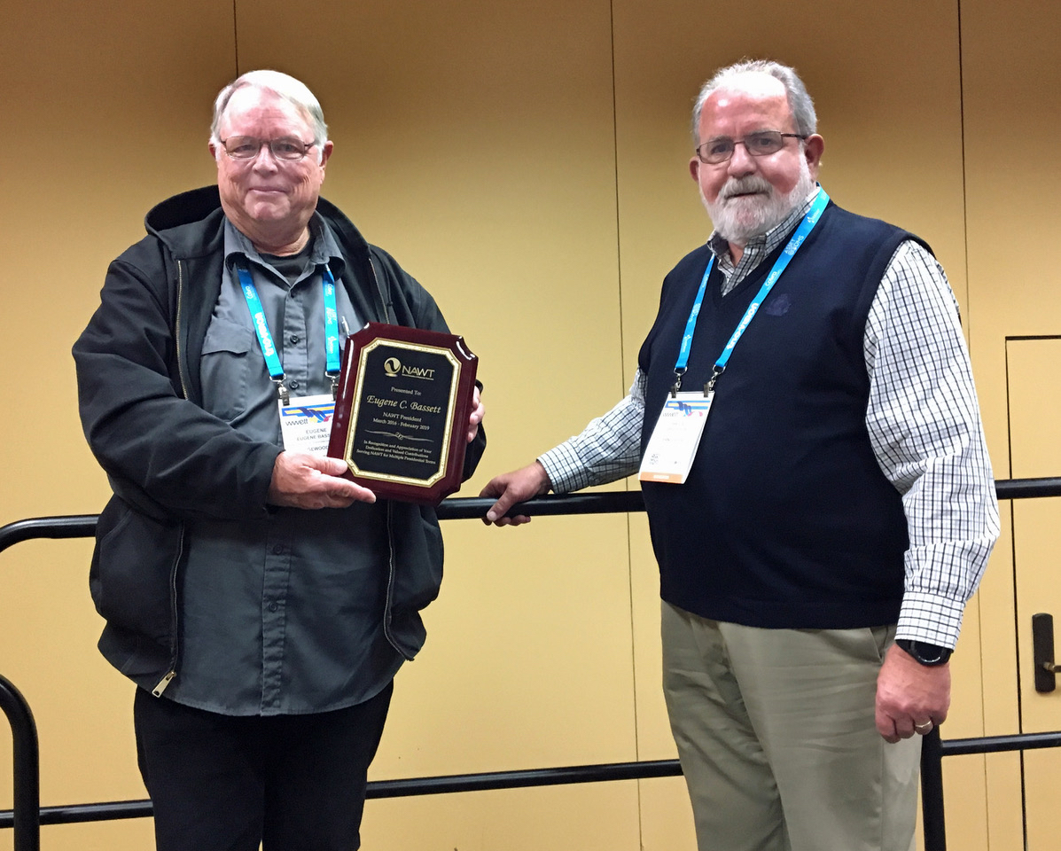 Gene Bassett, left, the outgoing president of the National Association of Wastewater Technicians, receives an award of appreciation from incoming president Bruce Fox.