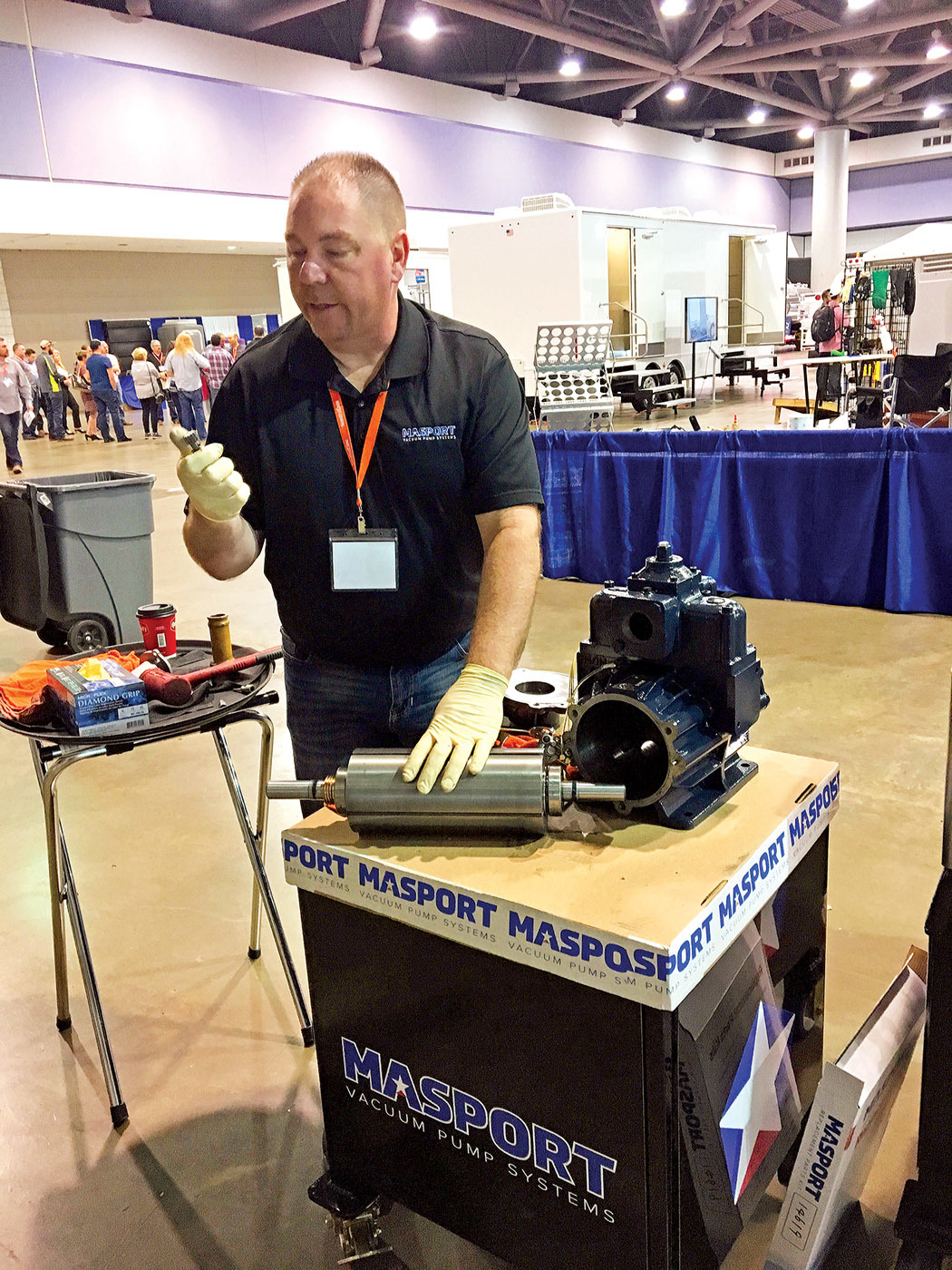 John Gilbert, sales manager at Masport, demonstrates vacuum pump teardown and inspection during the 2019 Portable Sanitation Association International conference. (Photo by Jim Kneiszel)