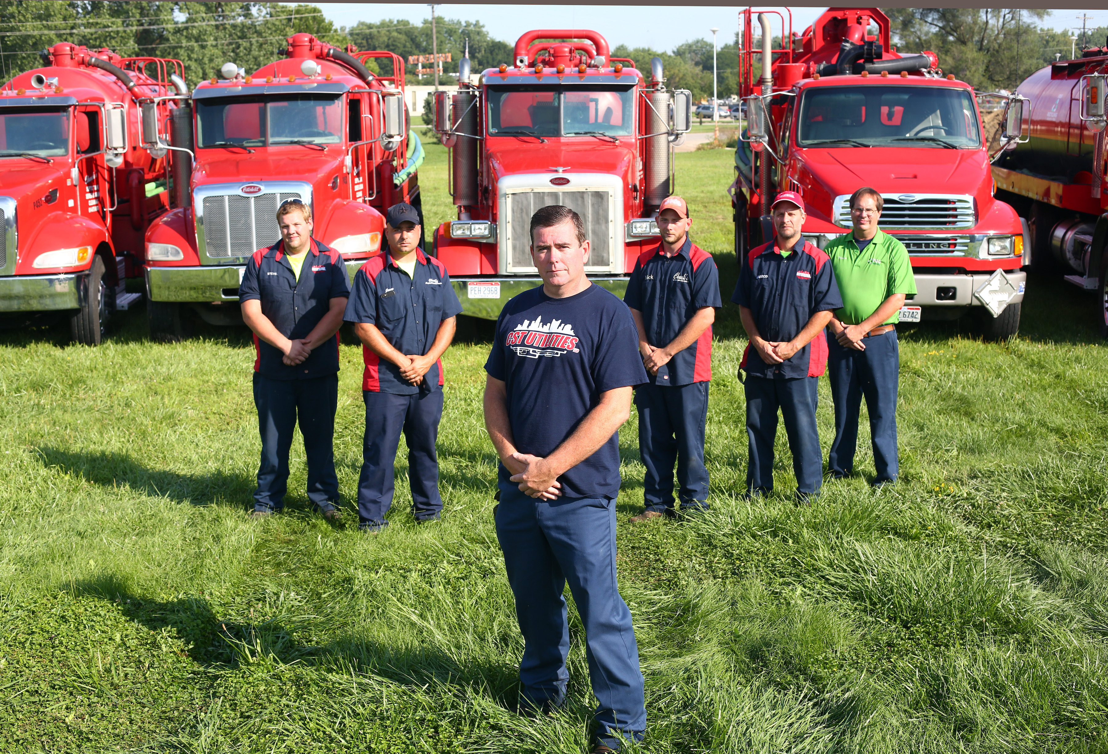 Chuck Lang, owner of Chuck's Septic Tank, Sewer & Drain Cleaning in Grove City, Ohio, front, stands with his septic tank service employees. (Photo by Amy Voigt)